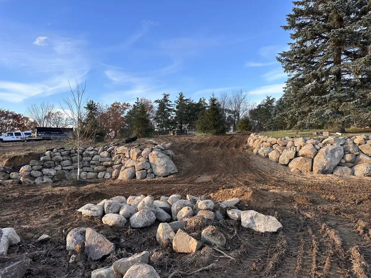 Natural boulder wall installation by Earth Art Landscaping
