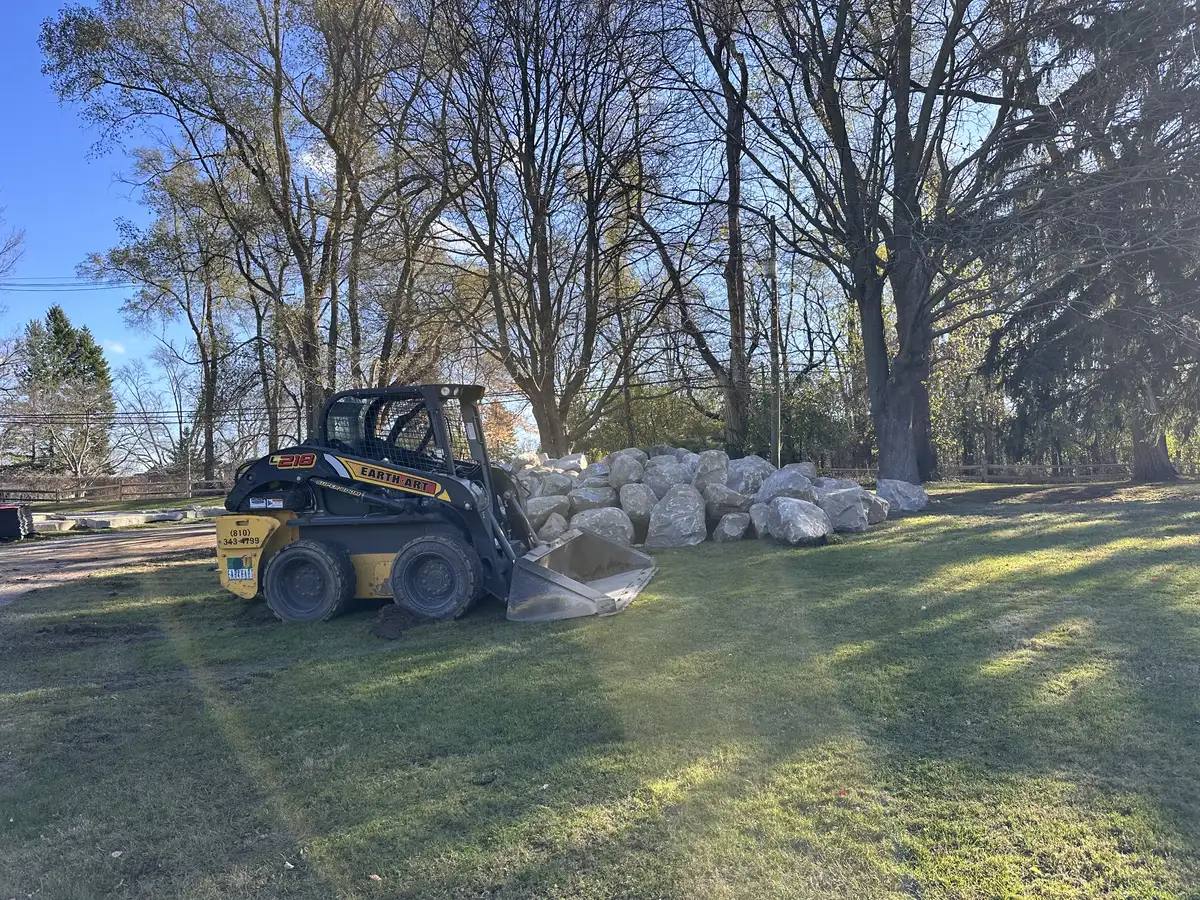 Earth Art Landscaping branded skid steer on jobsite